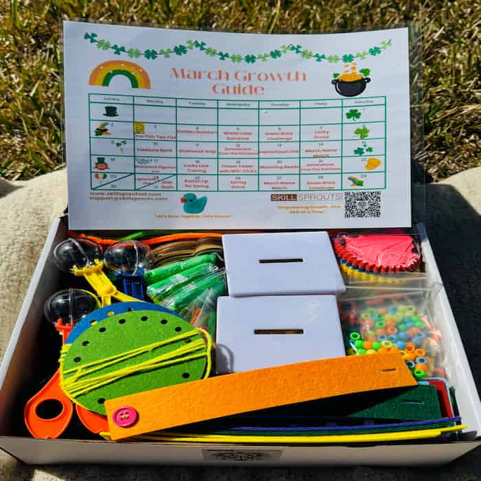 An open SkillSprouts OT Activity Box displaying various colorful educational supplies and tools for fine motor and sensory activities.