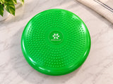 Sprout Cushion™ sensory balance cushion in bright green with textured surface and SkillSprouts OT logo, displayed on a light marble surface.
